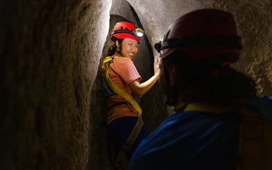 Adventurers exploring a narrow cavern in Rainforest Wild ASIA.