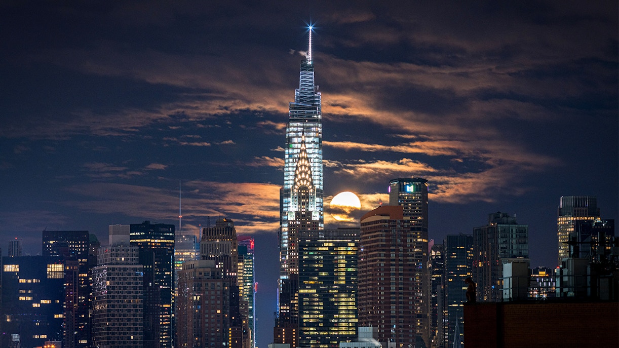 Summit One Vanderbilt observation deck illuminated at night, New York City skyline view.