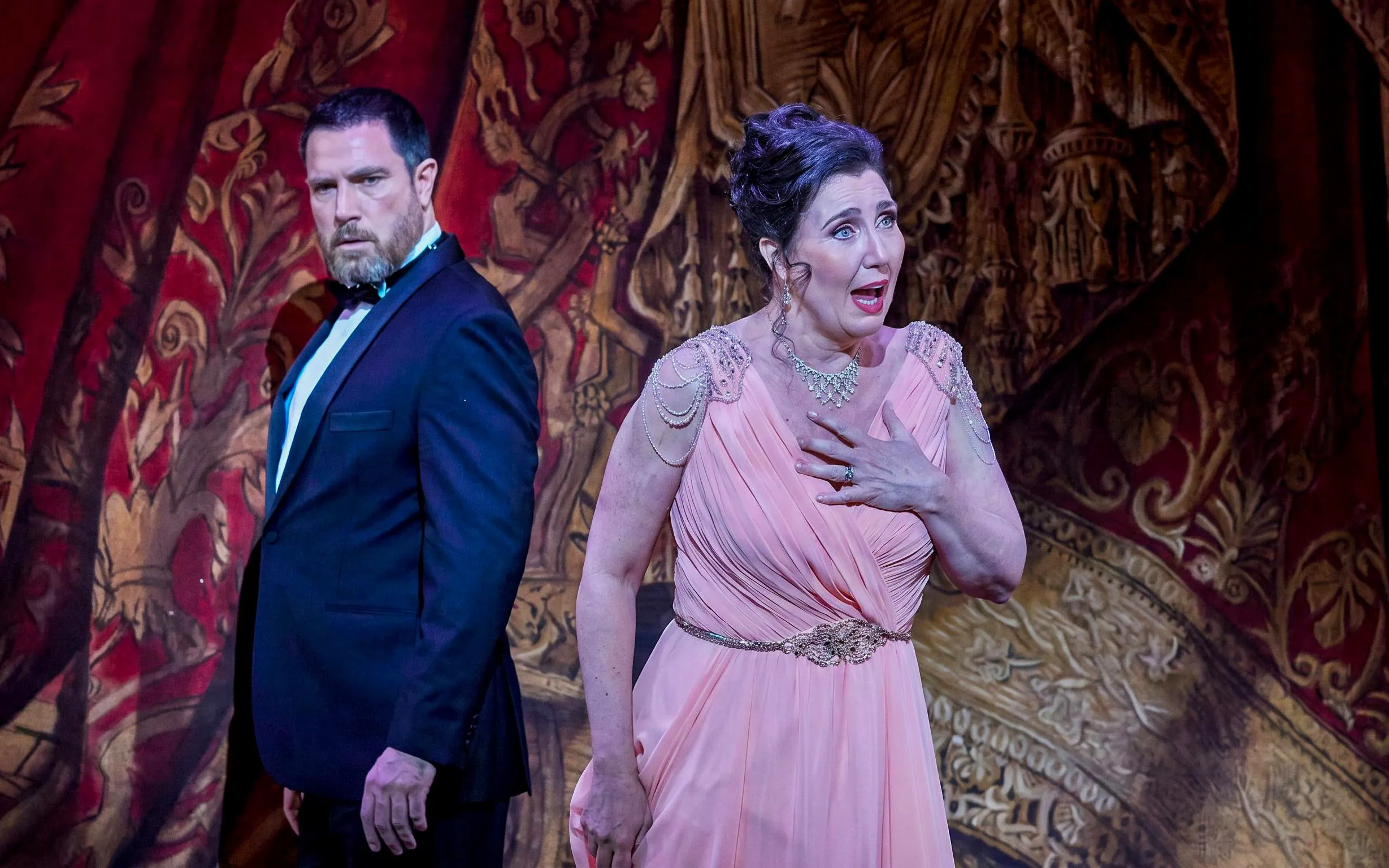 Actors performing a scene from My Fair Lady on stage with ornate backdrop.