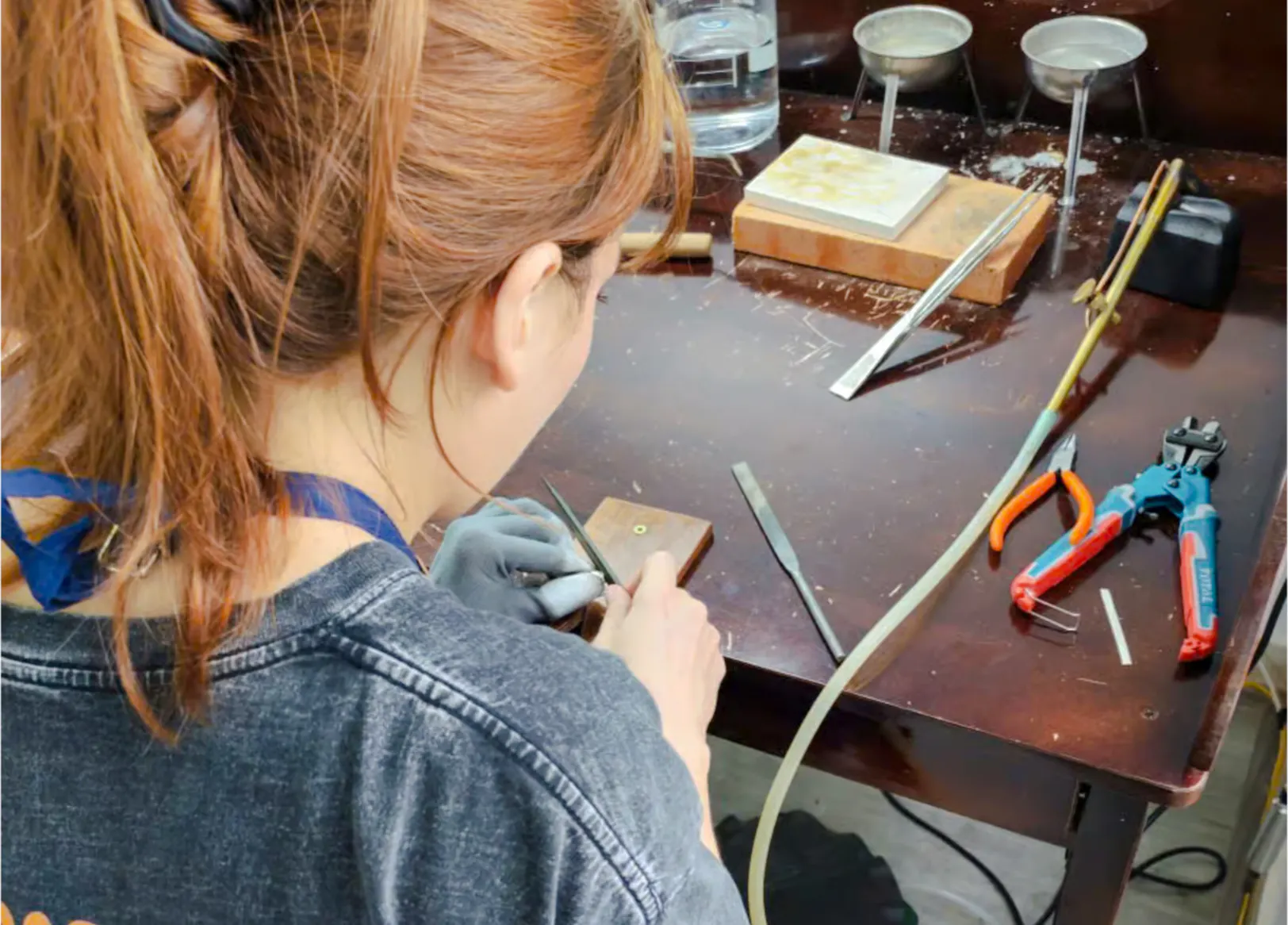 Jewelry making tools and instructor at a workshop in Da Nang.