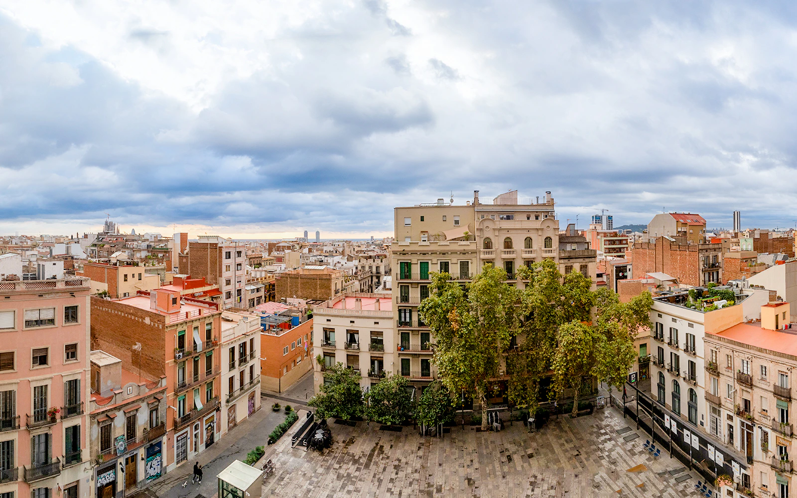 Placa del Sol in Barcelona with surrounding buildings and cloudy sky.