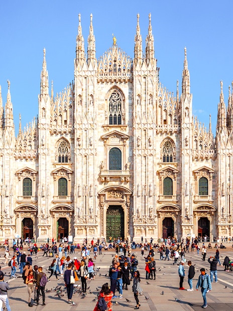 Duomo di Milano Cathedral exterior with visitors in the square, Milan, Italy.