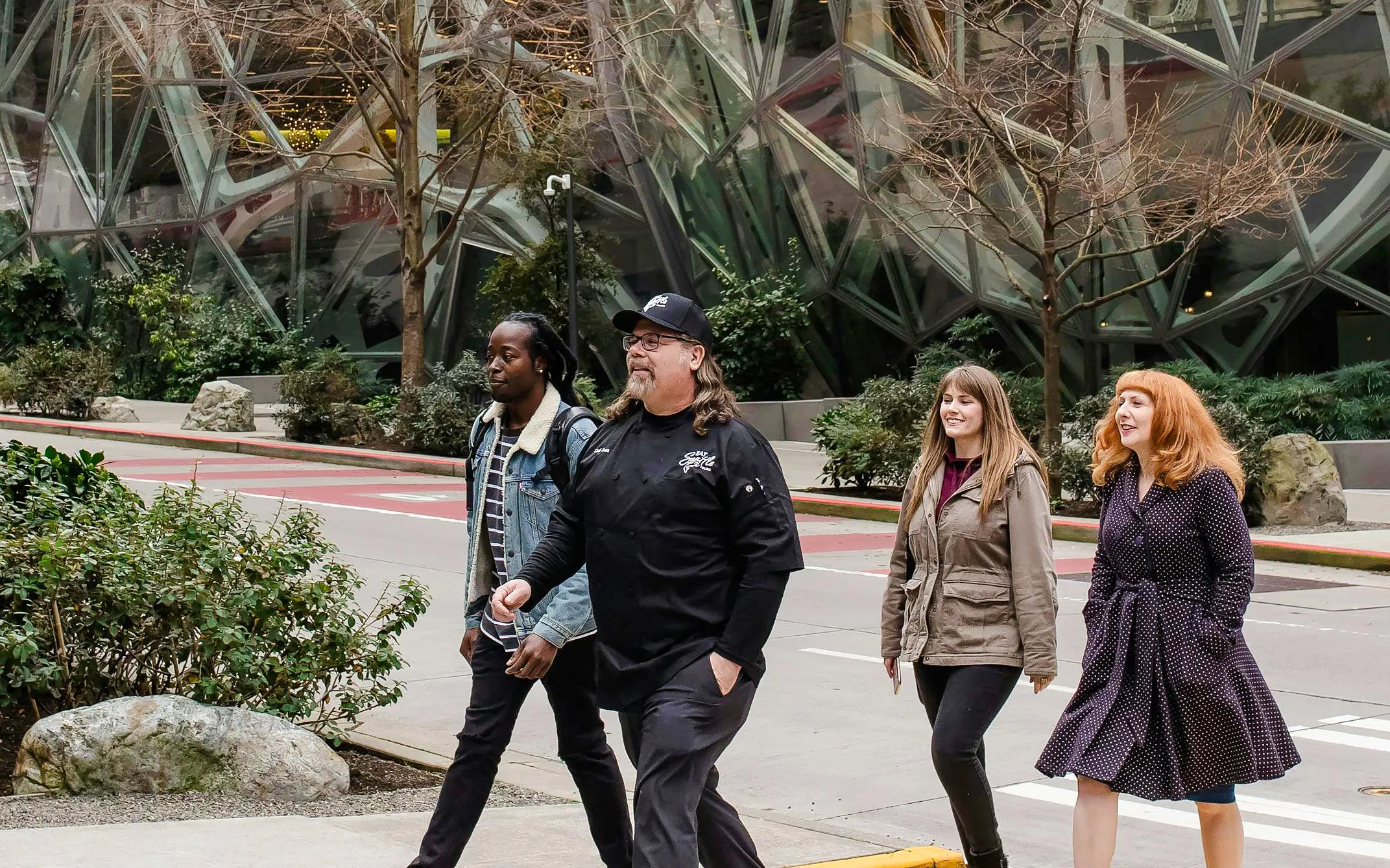 Group walking near Seattle's Amazon Spheres during happy hour tour.