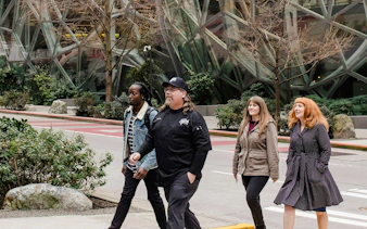 Group walking near Seattle's Amazon Spheres during happy hour tour.