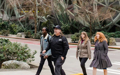 Group walking near Seattle's Amazon Spheres during happy hour tour.