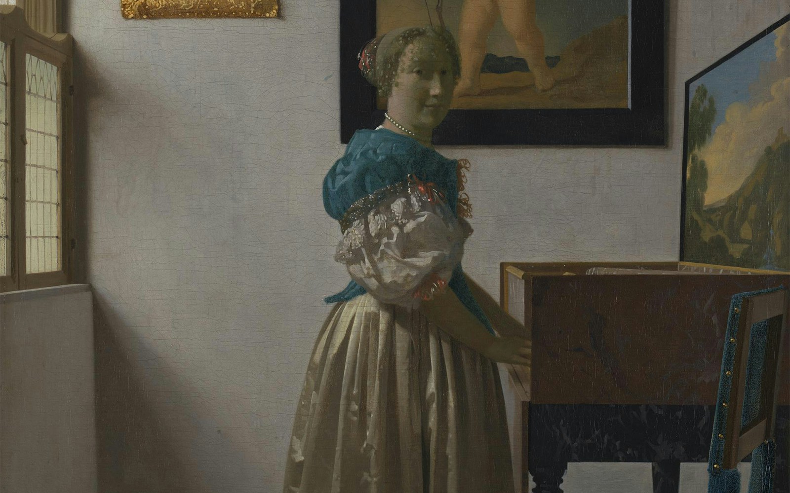 young woman standing at a virginal