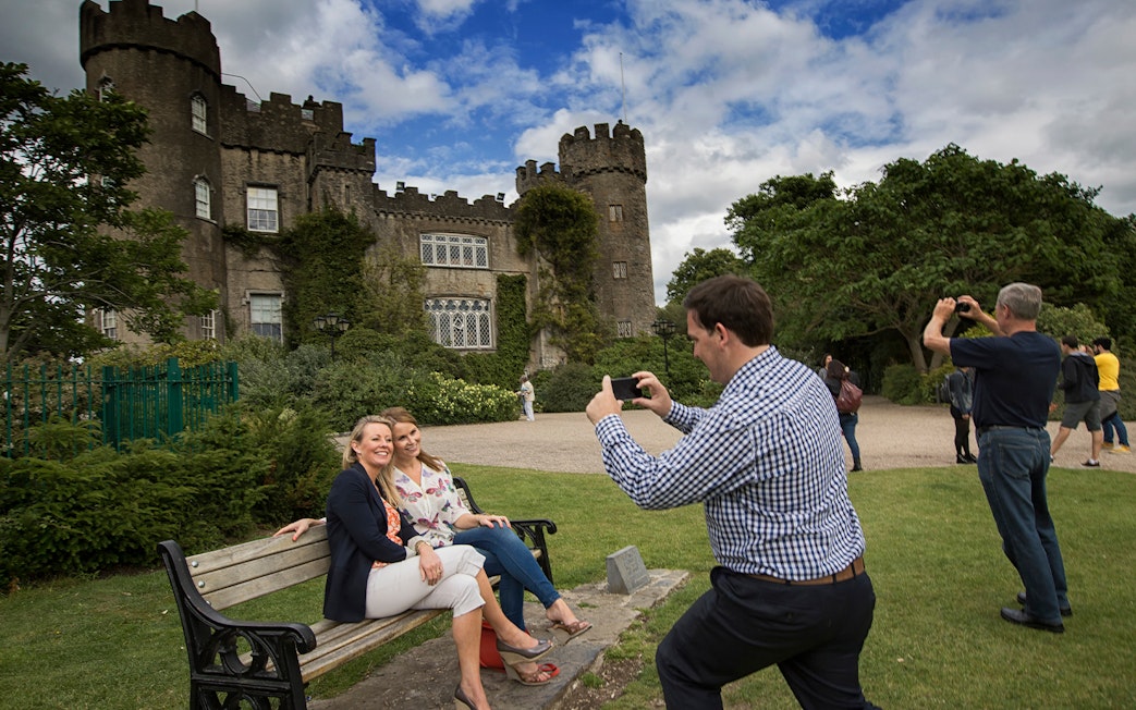 Visitors taking photos at Malahide Castle, Dublin with Go City: Dublin Explorer Pass.