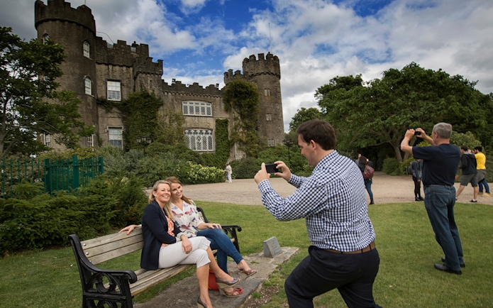 Visitors taking photos at Malahide Castle, Dublin with Go City: Dublin Explorer Pass.