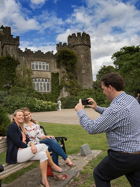 Visitors taking photos at Malahide Castle, Dublin with Go City: Dublin Explorer Pass.