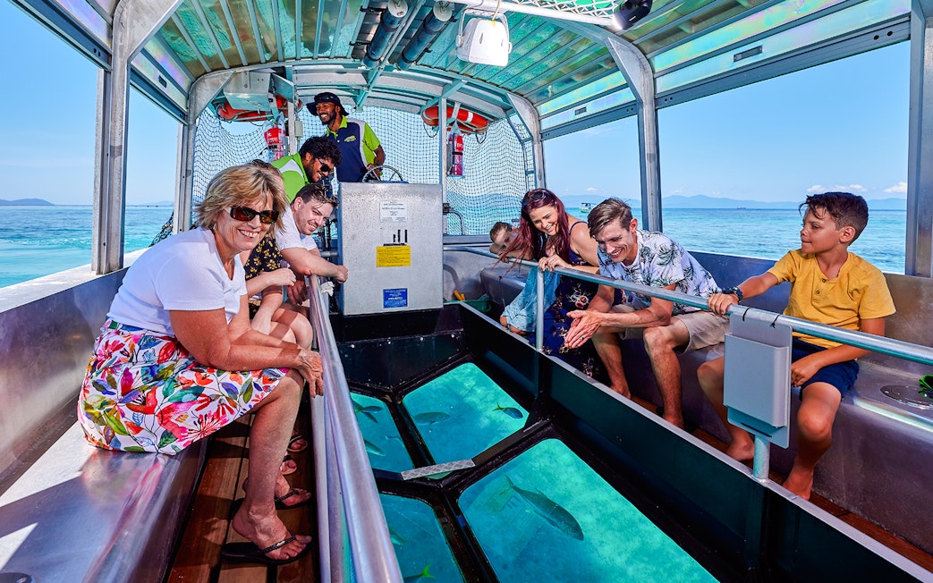 Tourists enjoying a glass-bottom boat tour near Fitzroy and Green Islands.