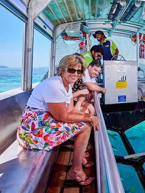 Tourists enjoying a glass-bottom boat tour near Fitzroy and Green Islands.