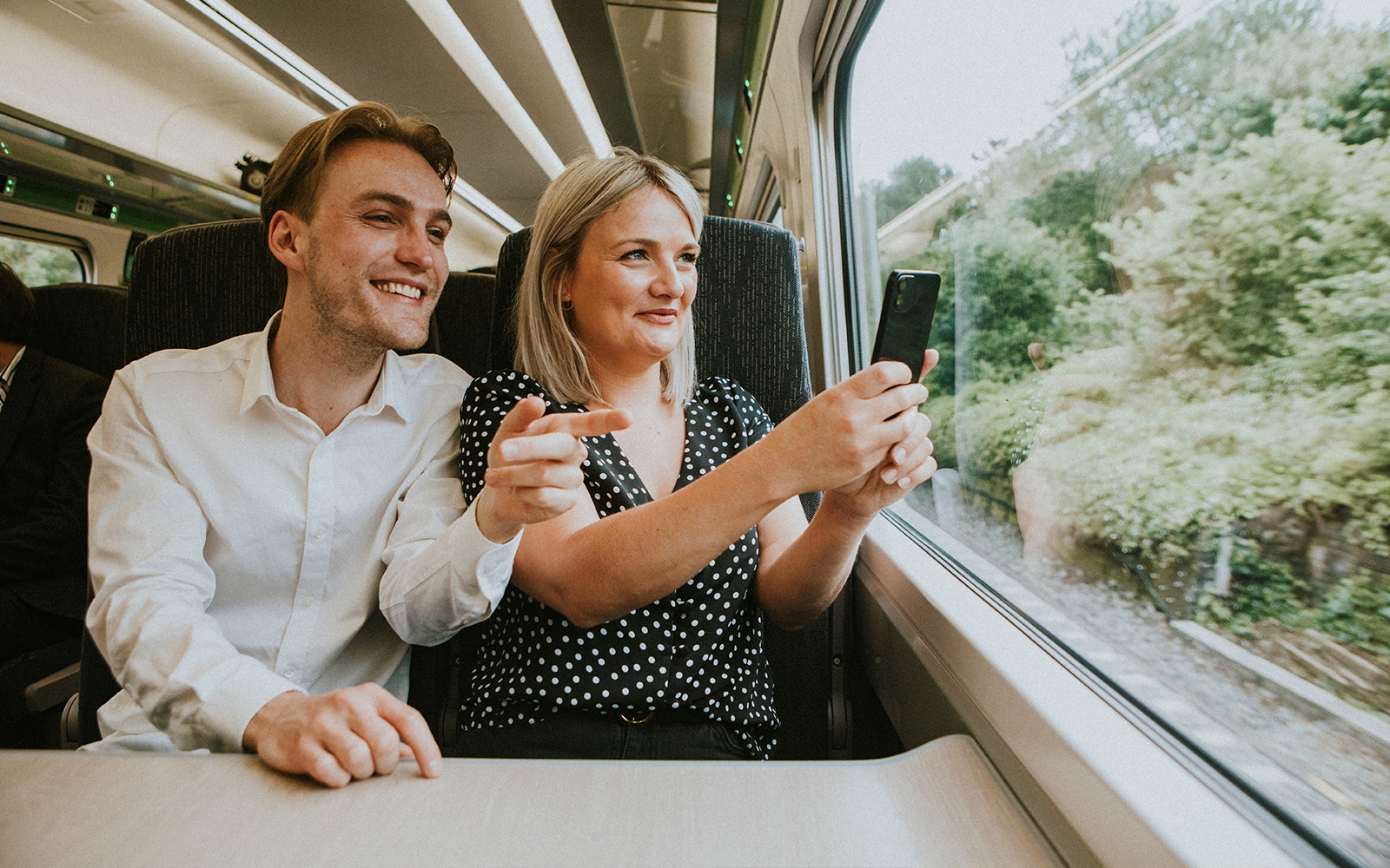 Couple taking a selfie on a train journey to London.