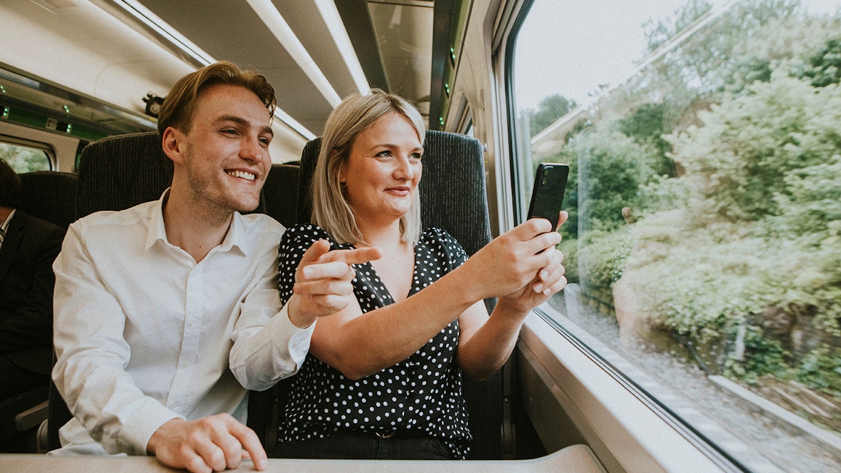 Couple taking a selfie on a train journey to London.