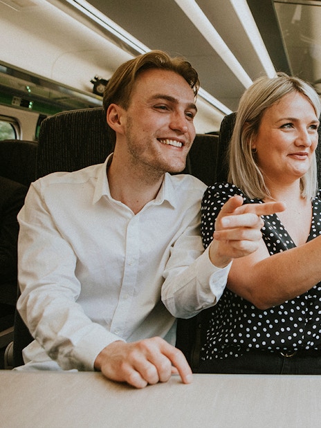 Couple taking a selfie on a train journey to London.