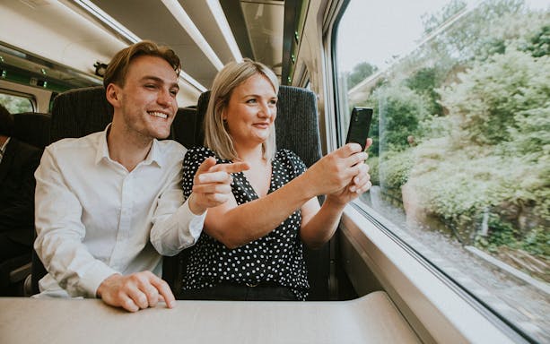 Couple taking a selfie on a train journey to London.