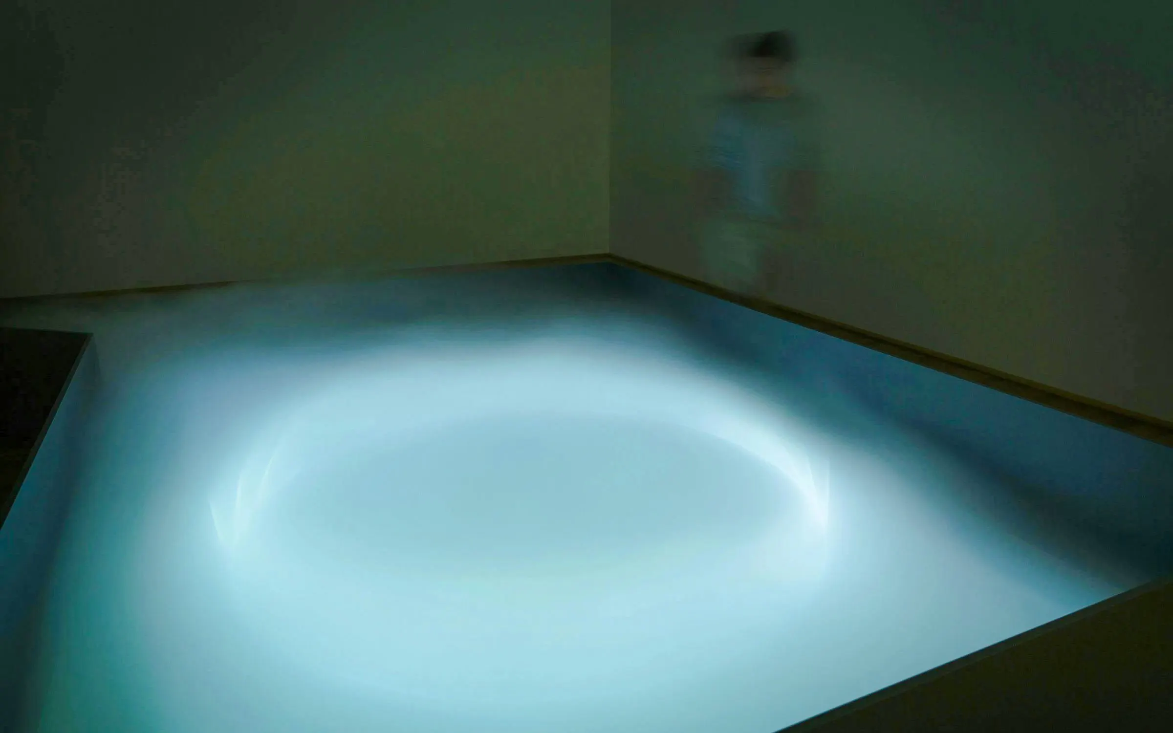 Centre Pompidou-Metz installation with glowing light and blurred figure.