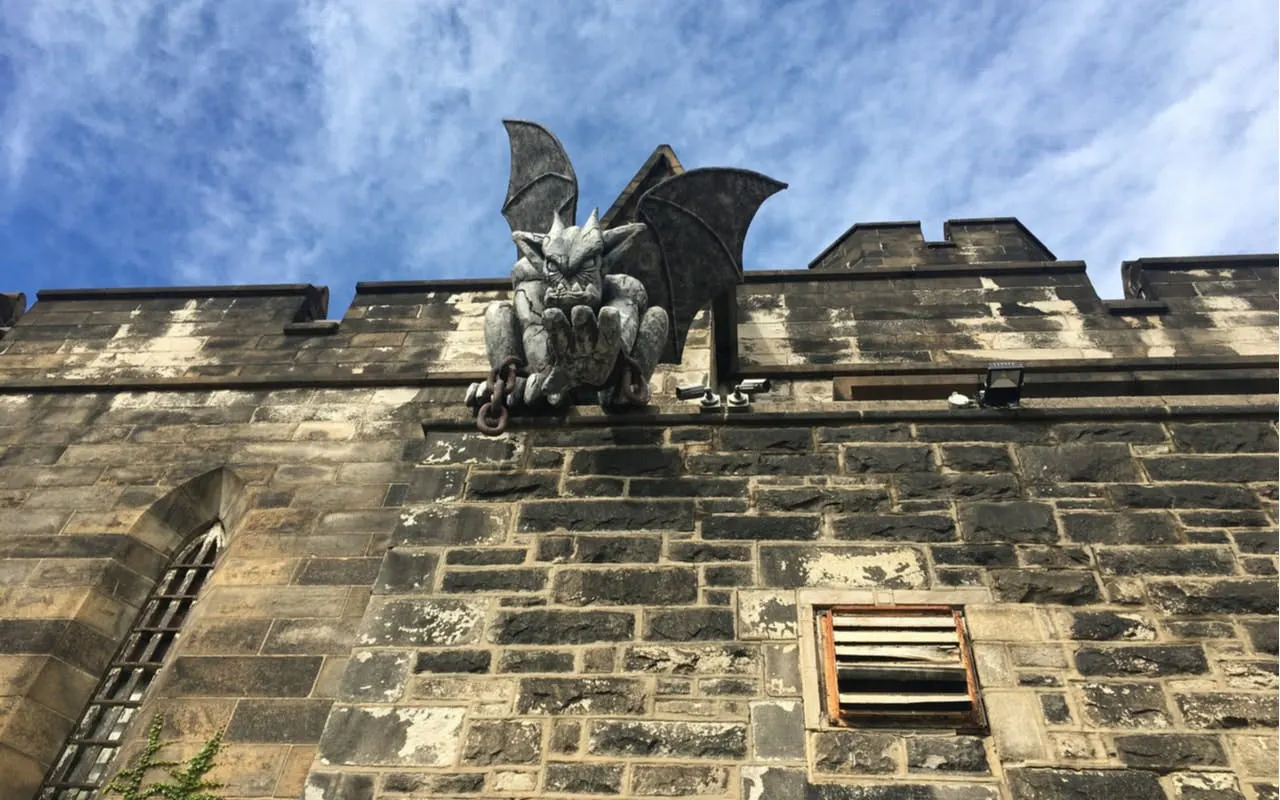 Gargoyle statue on Eastern State Penitentiary wall, Philadelphia, for self-guided city exploration game.