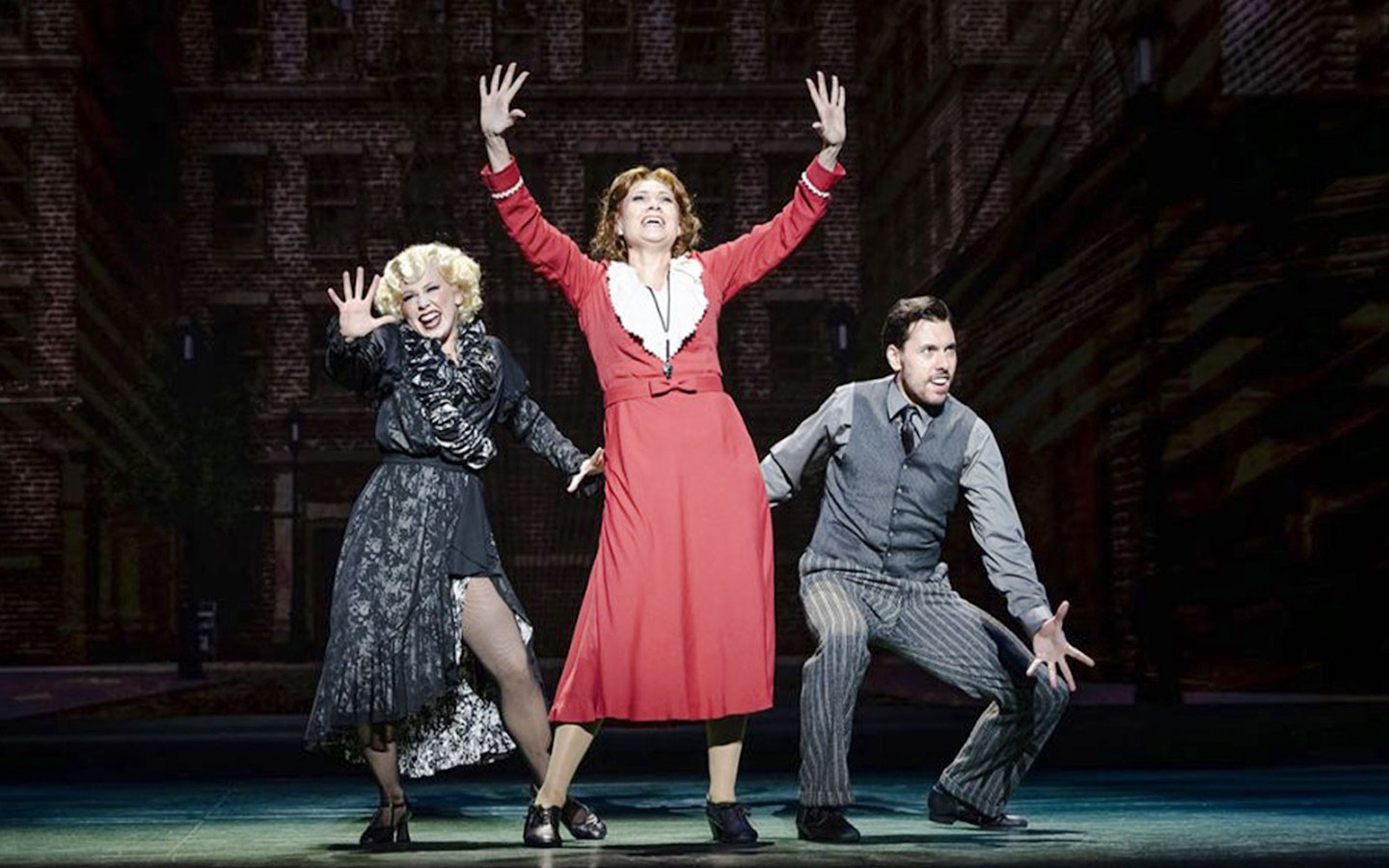 Performers on stage during an Annie musical scene.