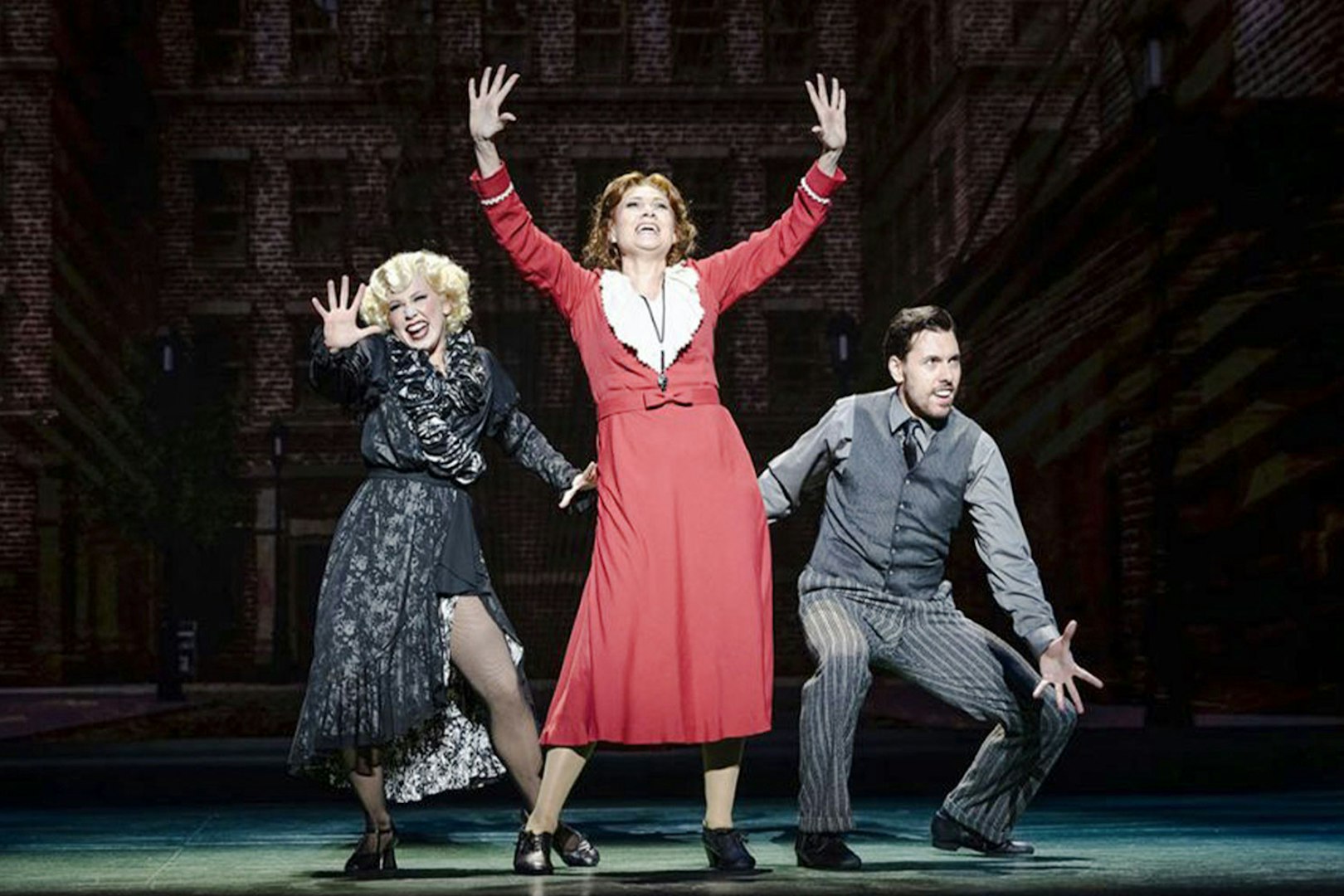 Performers on stage during an Annie musical scene.
