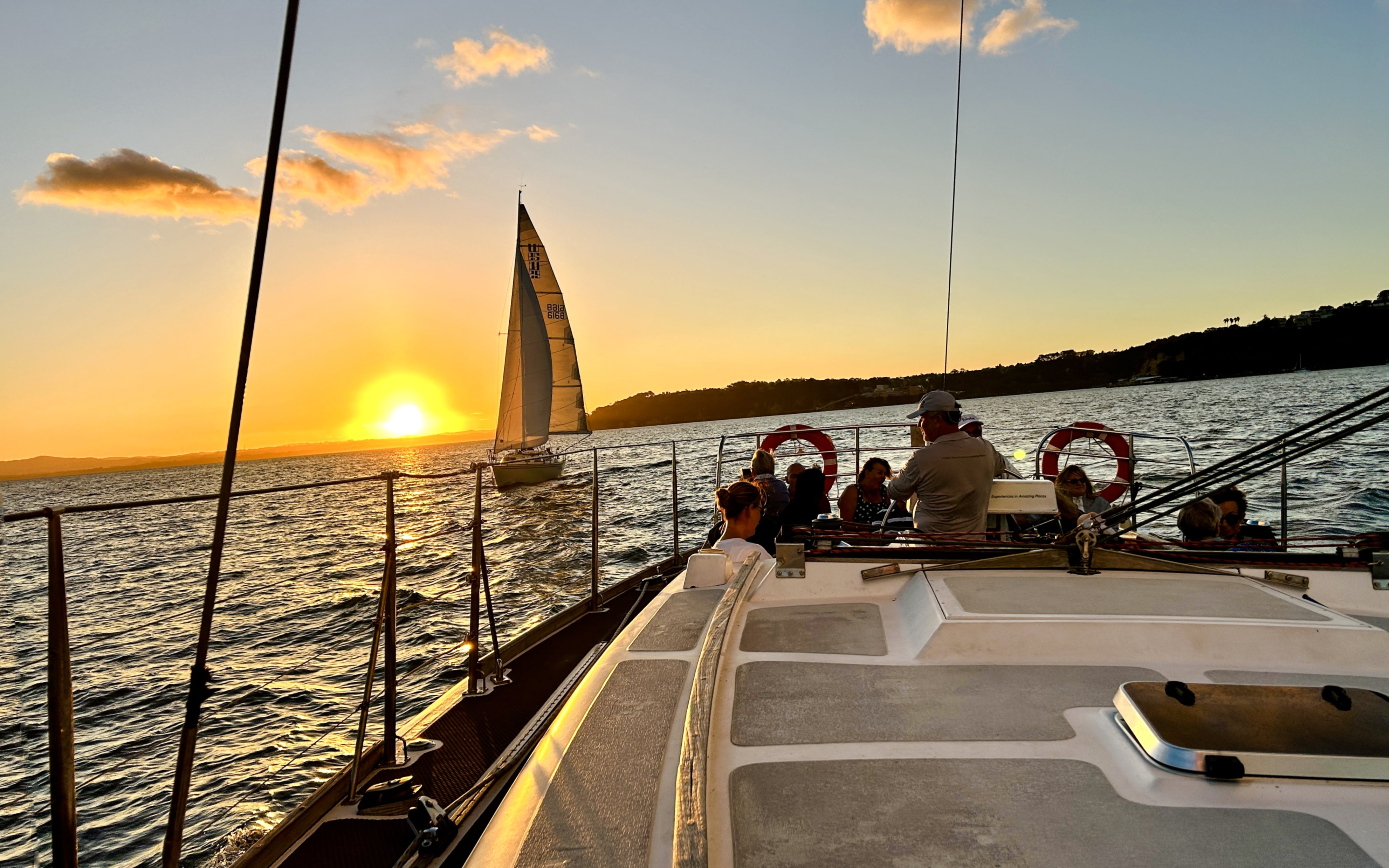 Sailing at sunset during a 3-course dinner cruise on Auckland Harbour.