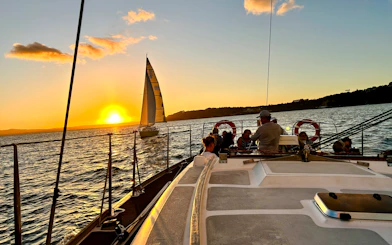 Sailing at sunset during a 3-course dinner cruise on Auckland Harbour.