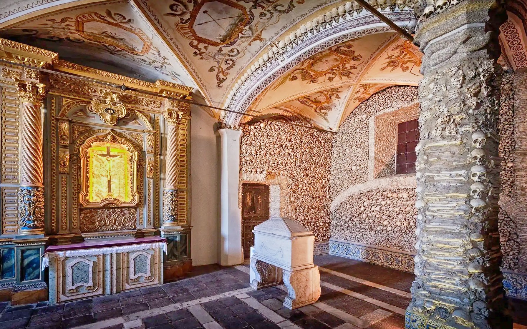 Capela dos Ossos interior with bone-adorned walls and ornate altar, Évora, Portugal.