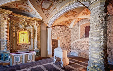 Capela dos Ossos interior with bone-adorned walls and ornate altar, Évora, Portugal.