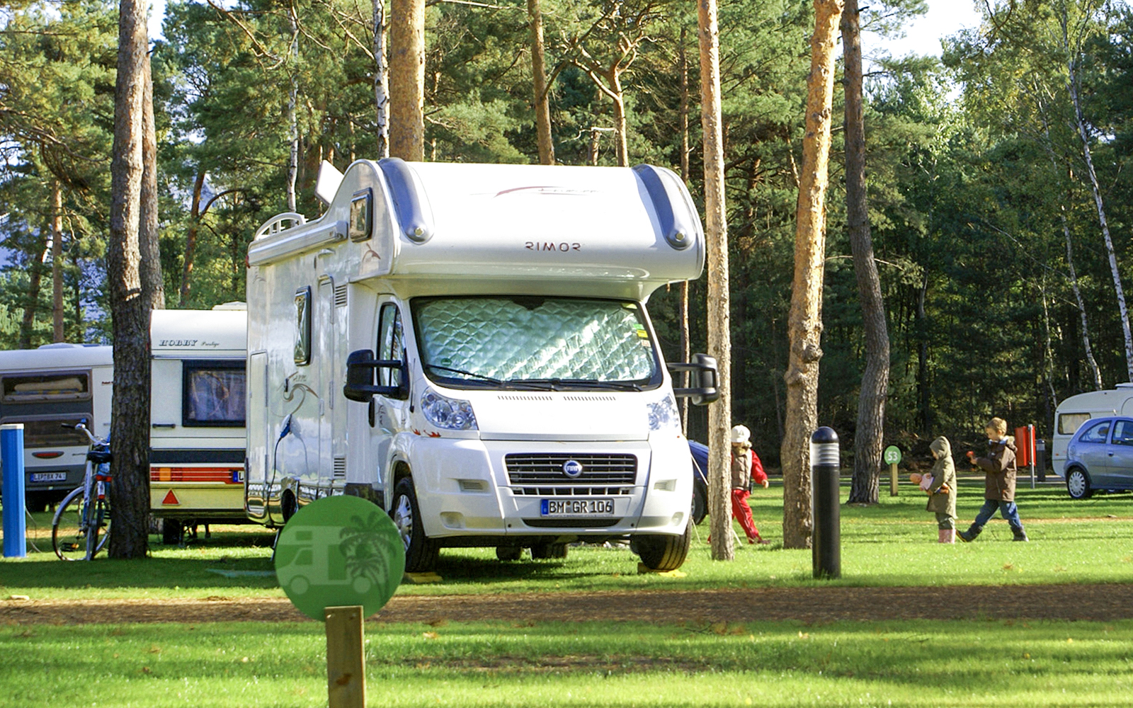Campervan parked in a forested area at Tropical Islands Resort.