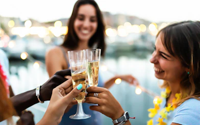 Guests toasting with drinks on Budapest Danube River sightseeing cruise.