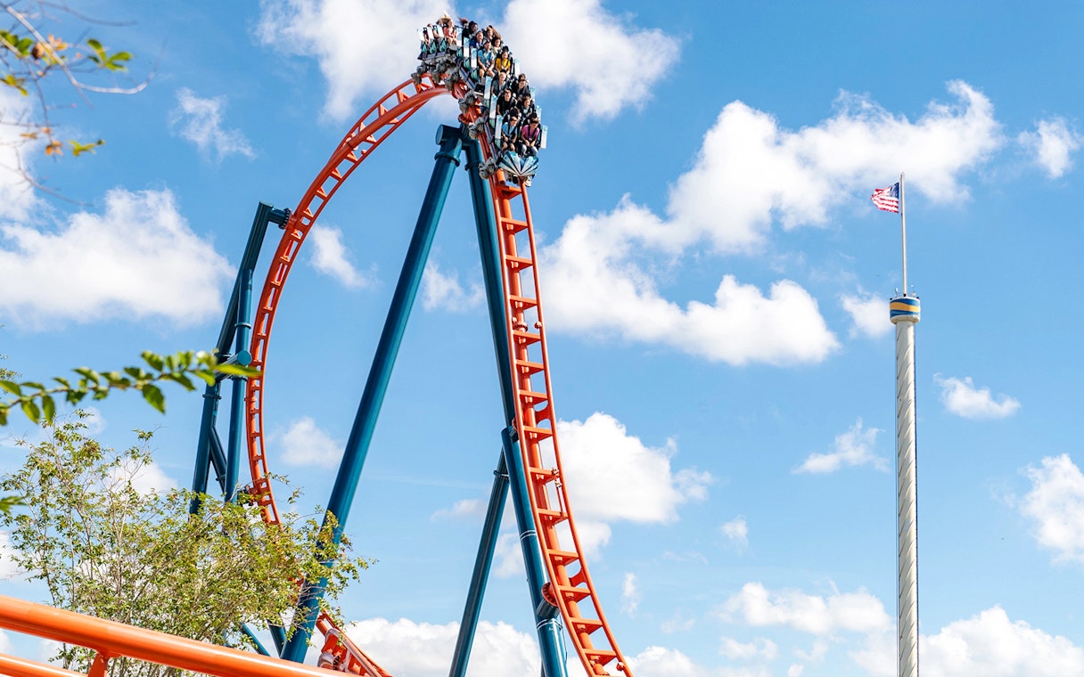 Ice Breaker roller coaster at SeaWorld Orlando with riders on a steep drop.