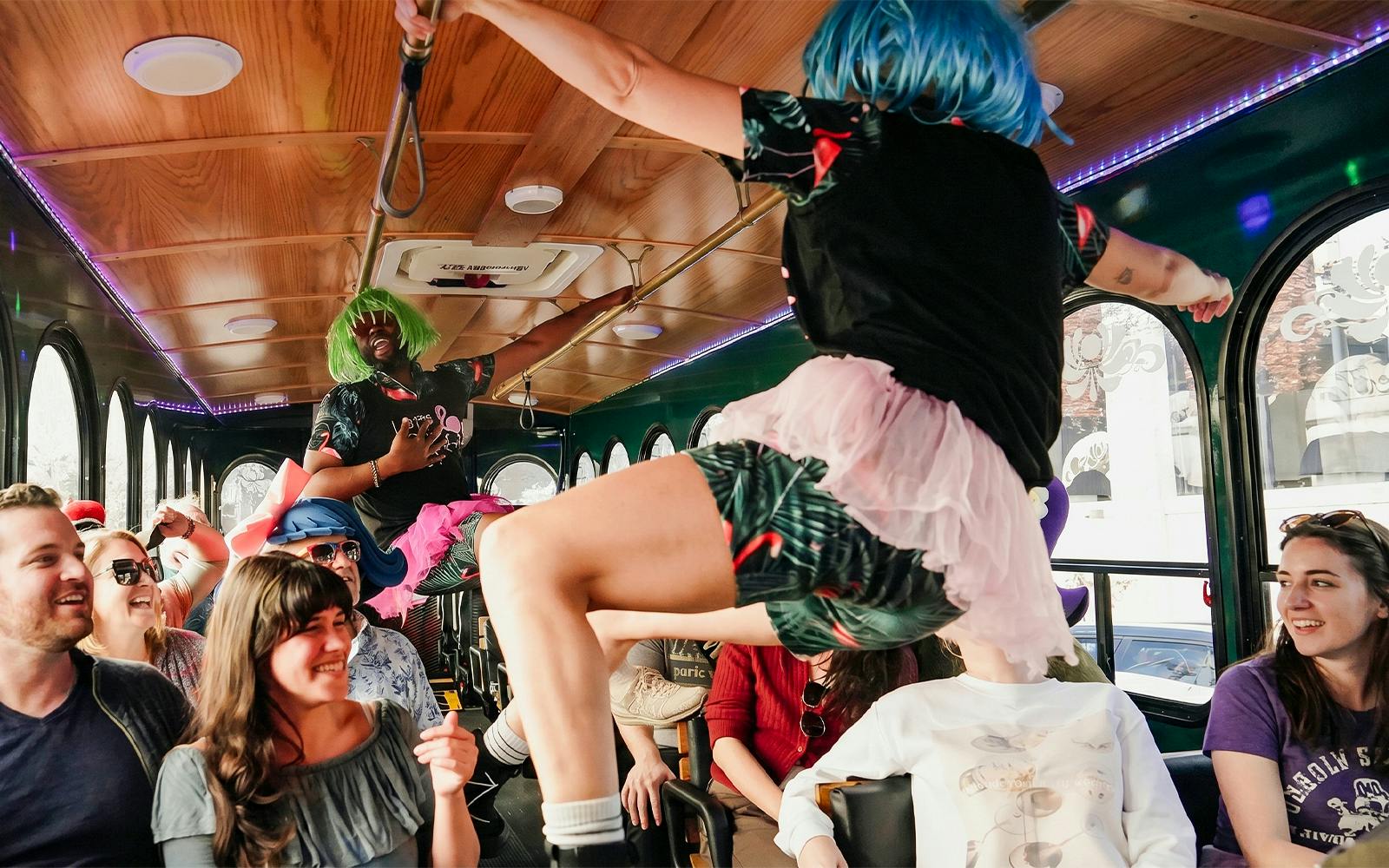 Performers in colorful wigs entertain passengers on the Nashville For Morons Comedy Trolley Tour.