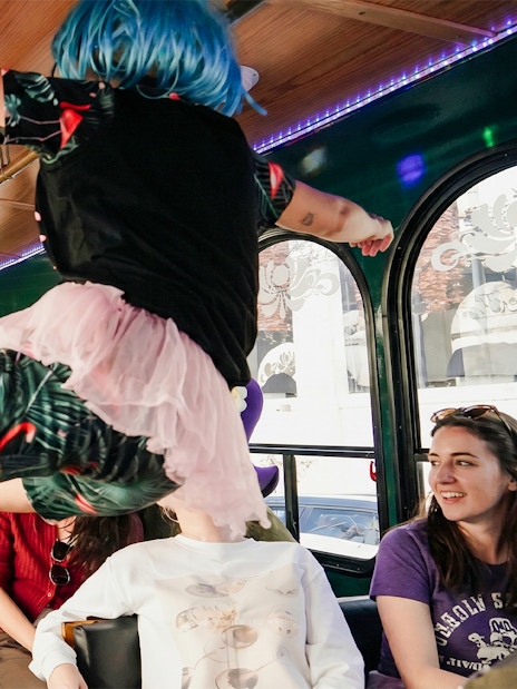 Performers in colorful wigs entertain passengers on the Nashville For Morons Comedy Trolley Tour.