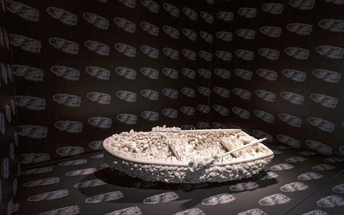 Boat sculpture with white protrusions in Yayoi Kusama exhibition at Stedelijk Museum Amsterdam.