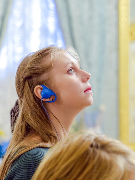 Woman using audio guide inside Hungarian Parliament.