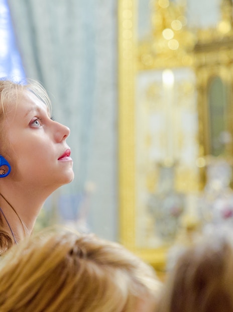 Woman using audio guide inside Hungarian Parliament.