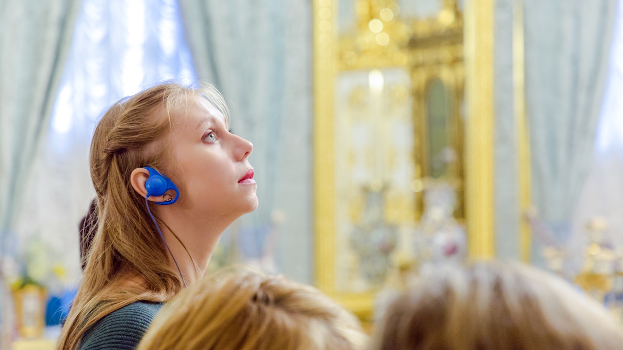 Woman using audio guide inside Hungarian Parliament, Budapest.