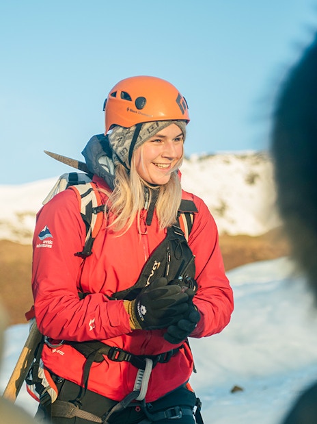 Guests hiking on Vatnajökull Glacier in Iceland, wearing helmets and winter gear.