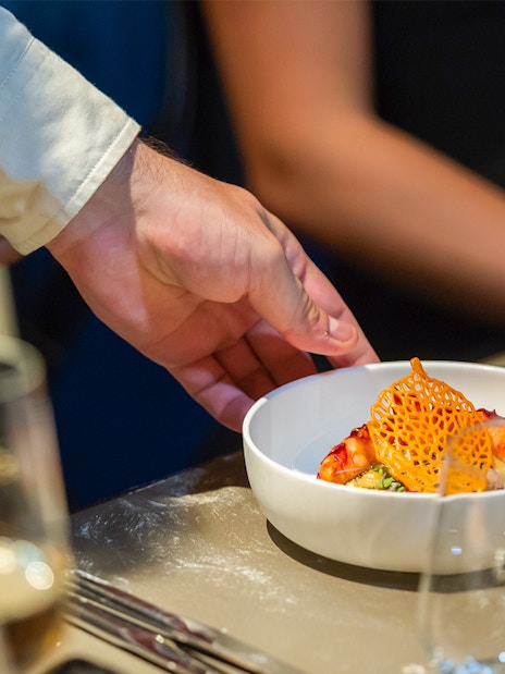 Waiter serving a gourmet dish at Madame Brasserie, Paris.
