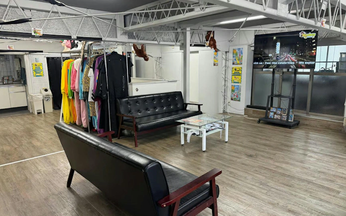Go-karting gear room with costumes and seating area for Shibuya Crossing & Tokyo Tower tour.