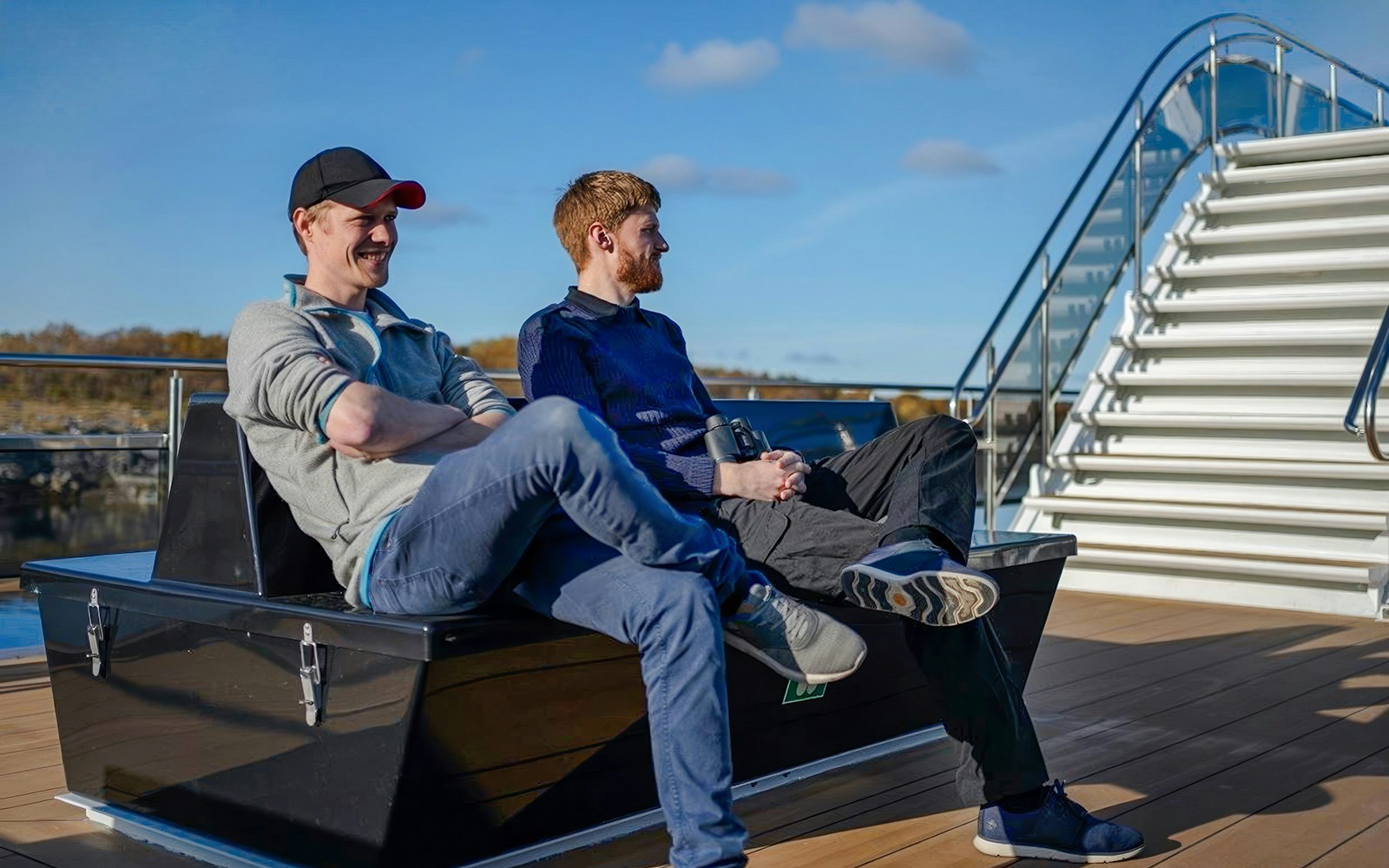 People relaxing on deck during Silent Trollfjord Cruise, Lofoten.