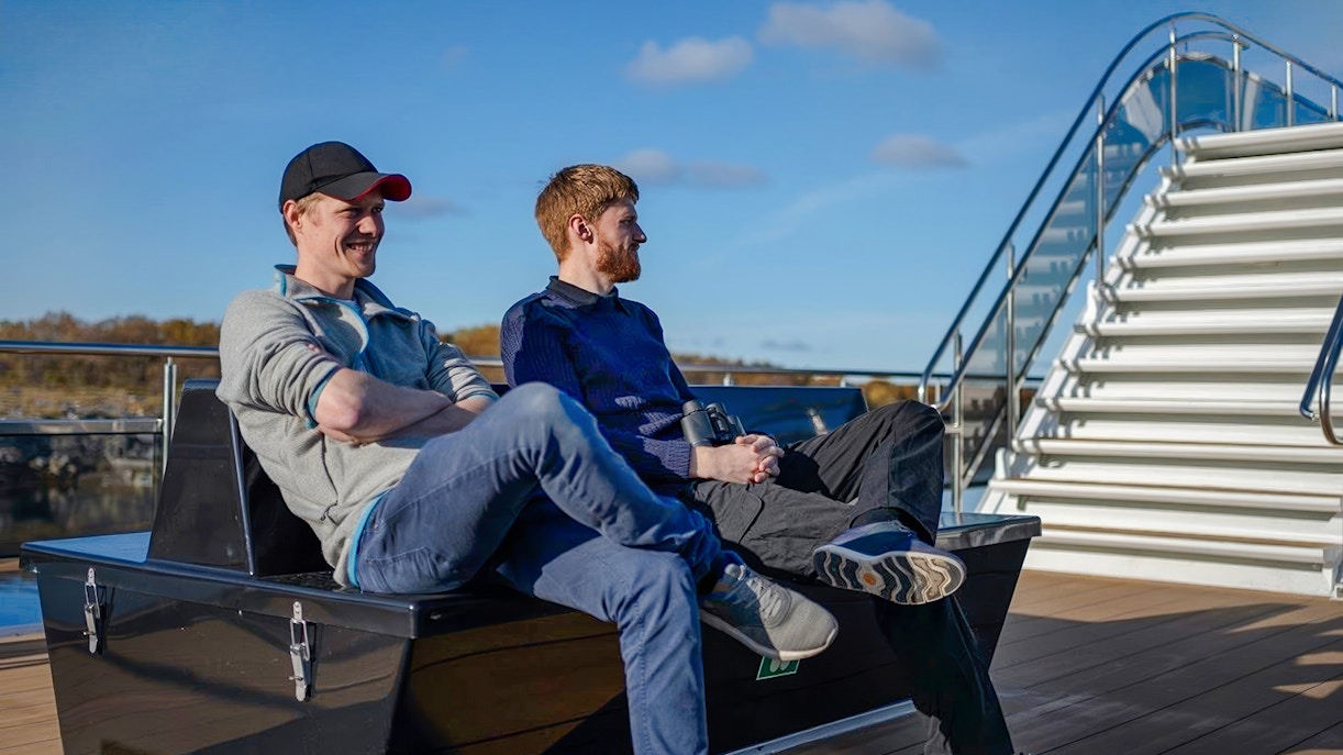 People relaxing on deck during Silent Trollfjord Cruise, Lofoten.