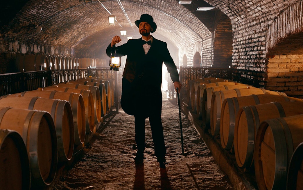 Don Isidro holding a lantern in the wine cellar at Concha y Toro vineyard, Chile.
