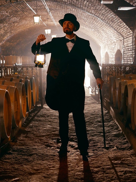 Don Isidro holding a lantern in the wine cellar at Concha y Toro vineyard, Chile.