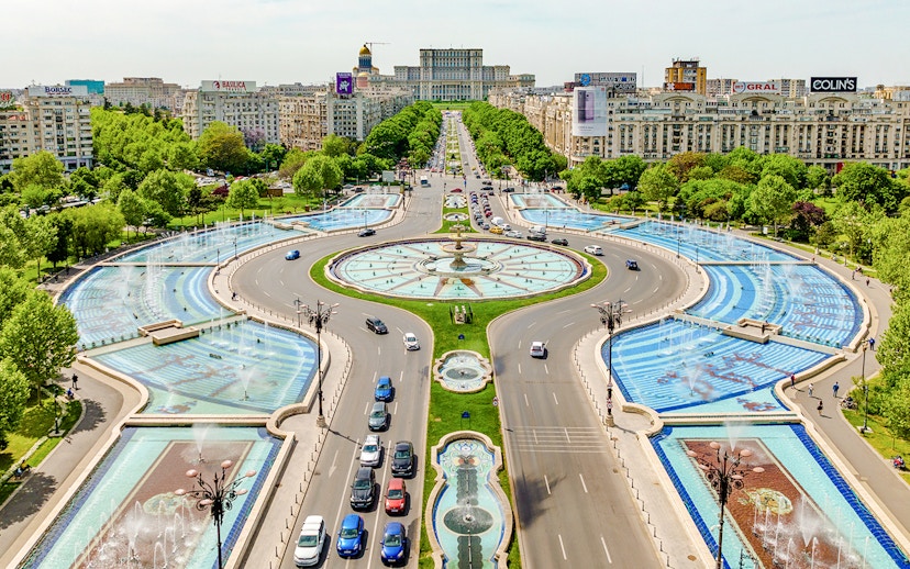 Aerial view of Unirii Square fountains and traffic in Bucharest, Romania.
