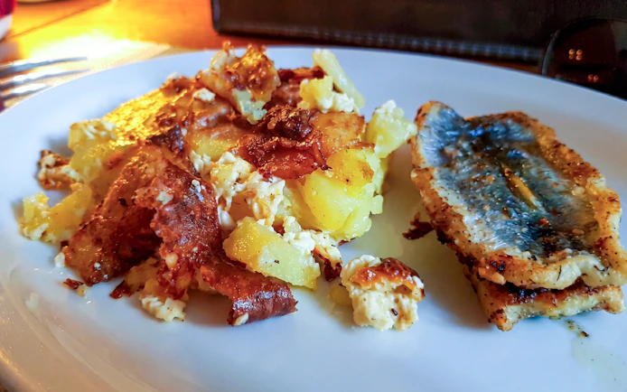 Traditional Estonian potato and fish dish on a plate in Tallinn.