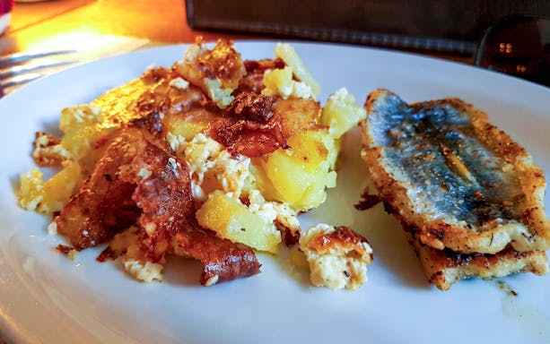 Traditional Estonian potato and fish dish on a plate in Tallinn.