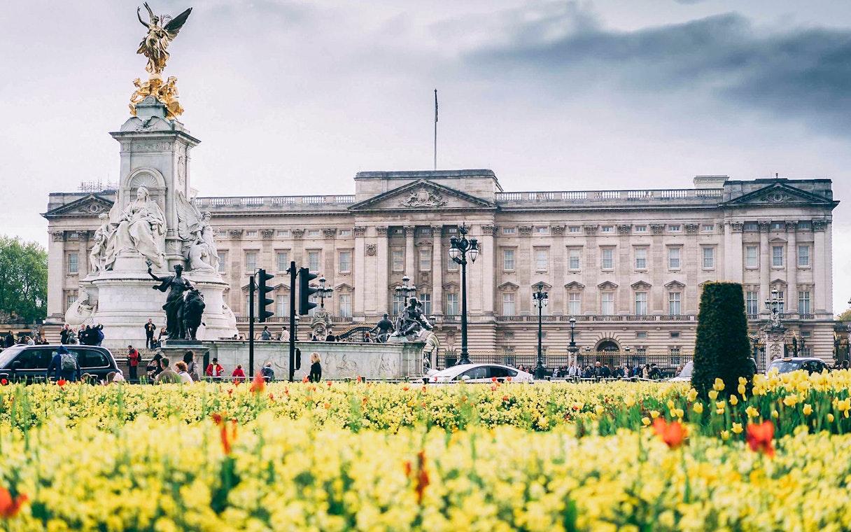Buckingham Palace with Victoria Memorial and blooming flowers, part of Tower Bridge & Westminster Walking Tour.