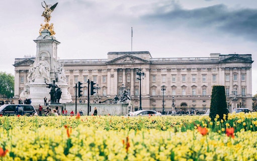 Buckingham Palace with Victoria Memorial and blooming flowers, part of Tower Bridge & Westminster Walking Tour.