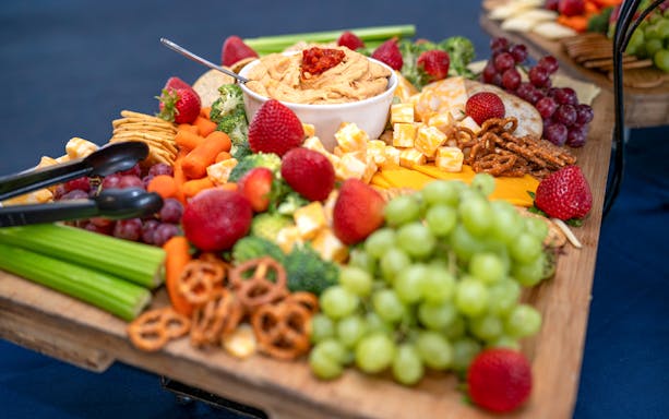 Assorted fruits, vegetables, and cheese platter on Golden Glow Sunset Harbour Cruise.