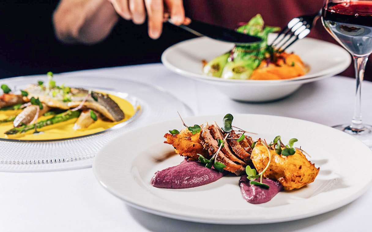 Dinner served at La Scène Dinner Show in Prague with gourmet dishes and wine.